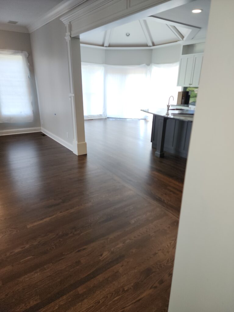 A room with hard wood floors and white walls.