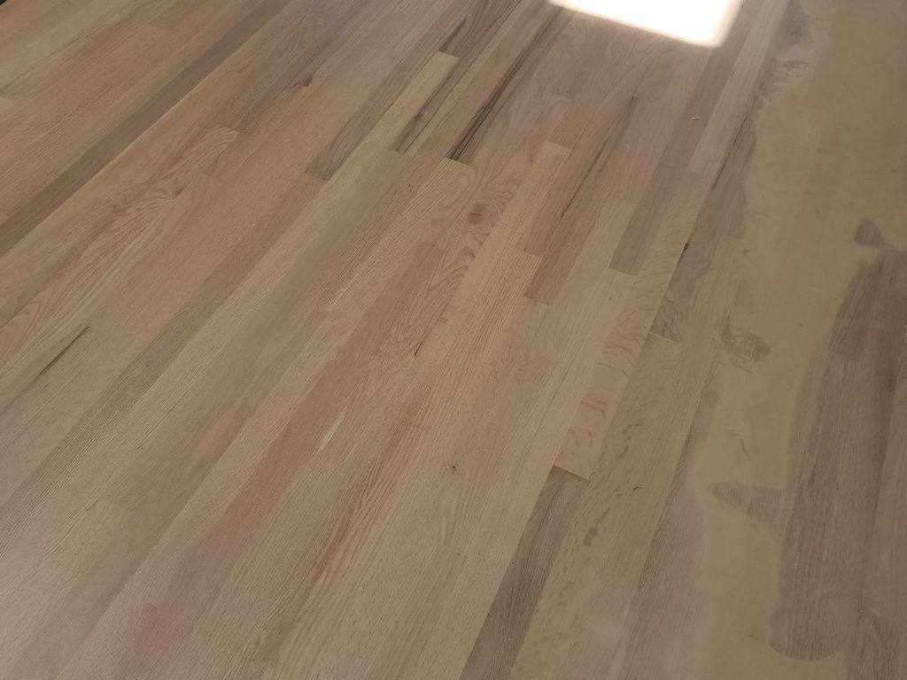 A wooden floor with some light wood on it