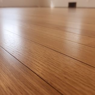 A close up of the wood floor in a room.